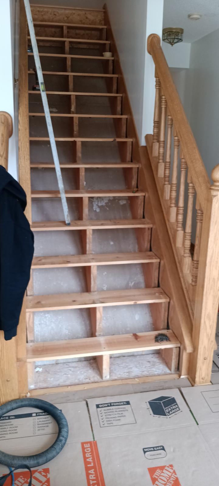 Staircase stripped down to its stringers and new framing during the structural repair